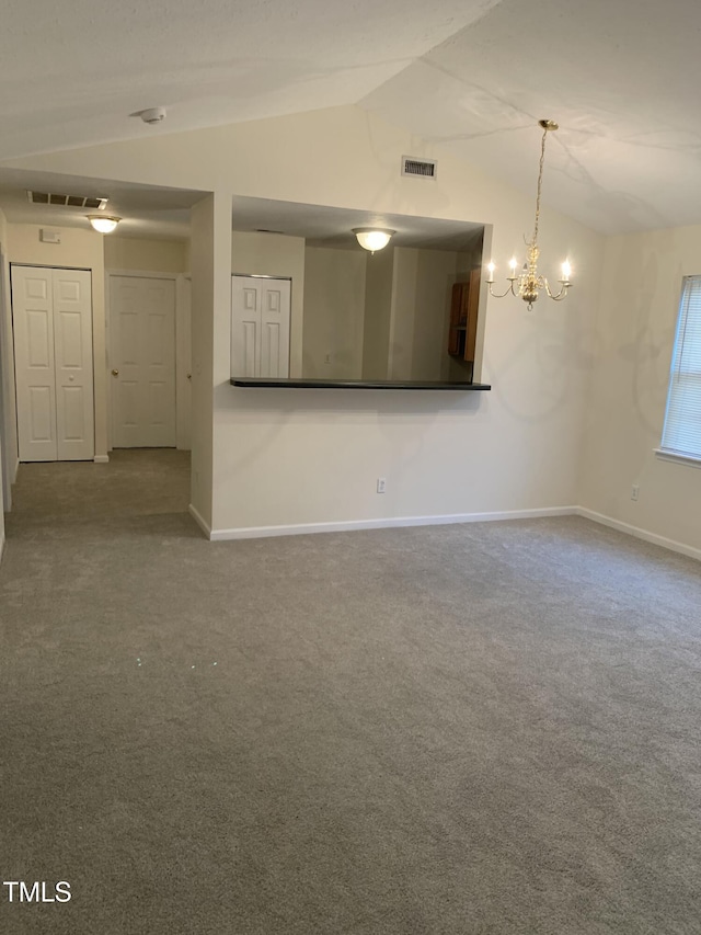 unfurnished living room featuring lofted ceiling, carpet, visible vents, and an inviting chandelier