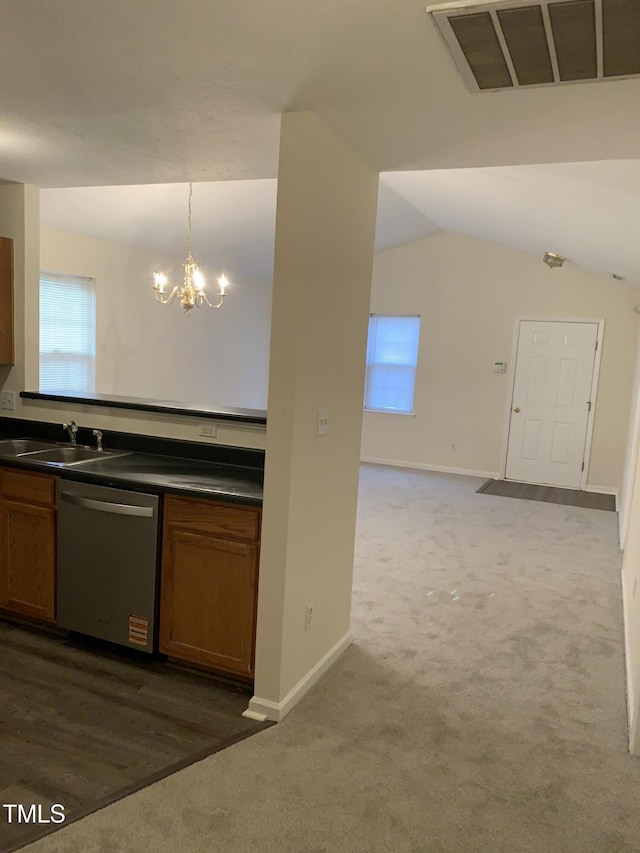 kitchen featuring dark countertops, visible vents, dishwasher, and a sink