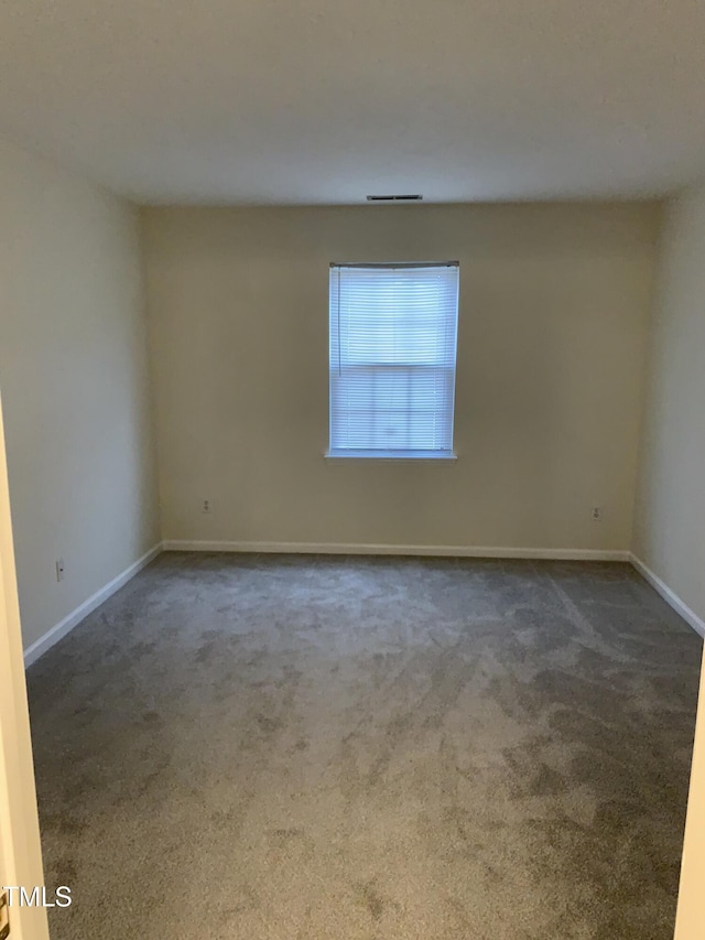 empty room with carpet flooring and baseboards