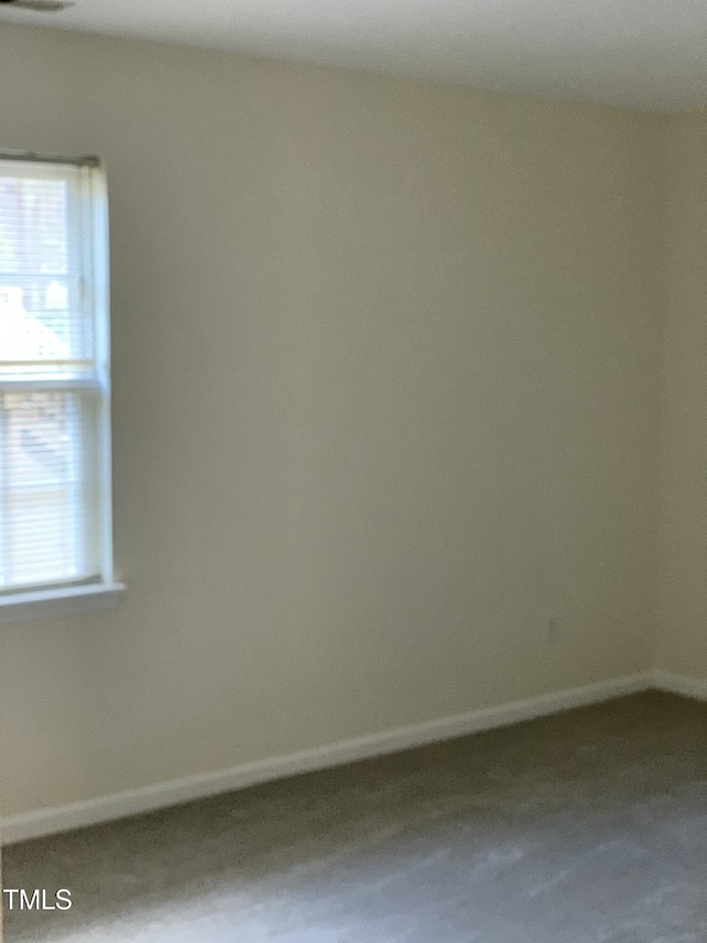 spare room featuring baseboards