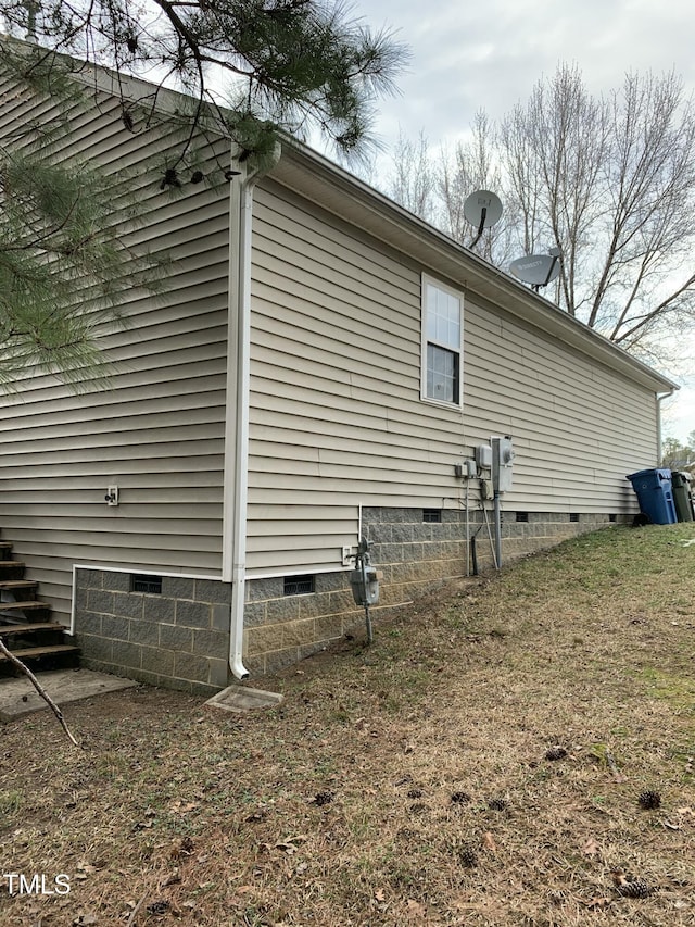 view of side of property with crawl space