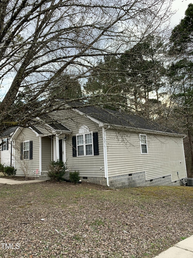 view of side of property featuring crawl space and central air condition unit