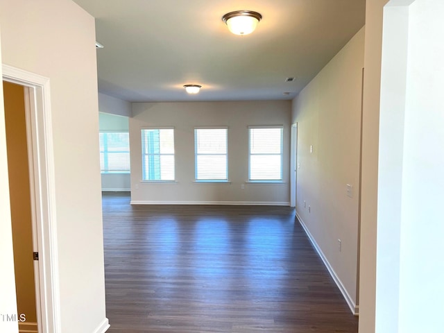 unfurnished room featuring dark hardwood / wood-style floors