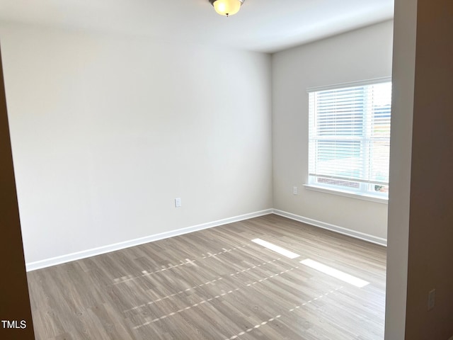 unfurnished room with light hardwood / wood-style flooring