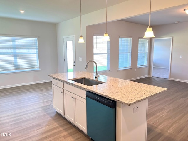 kitchen featuring sink, white cabinetry, light stone counters, dishwasher, and an island with sink