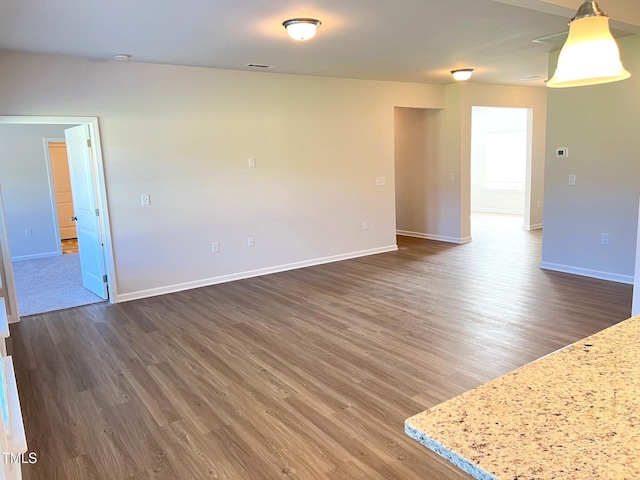 unfurnished room with dark hardwood / wood-style flooring