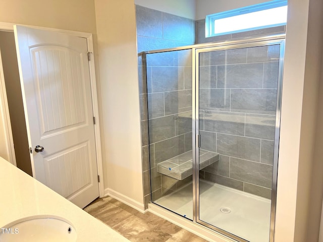 bathroom with vanity, hardwood / wood-style flooring, and walk in shower