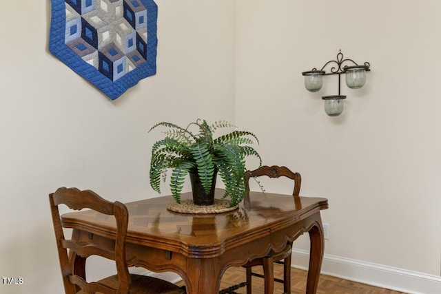 dining area with parquet flooring