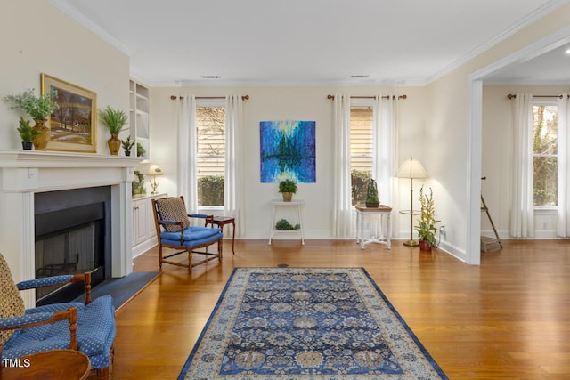 sitting room featuring hardwood / wood-style floors and ornamental molding