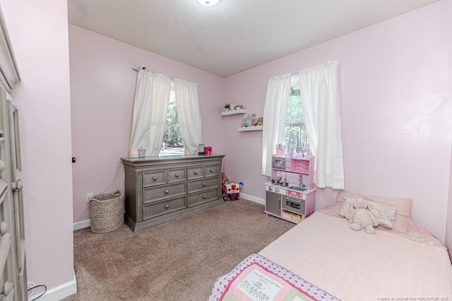 carpeted bedroom with a textured ceiling