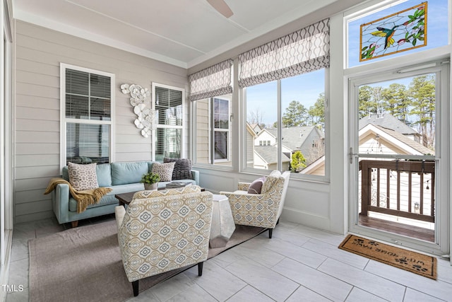 sunroom / solarium featuring a ceiling fan