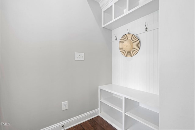 mudroom with dark wood-style floors and baseboards