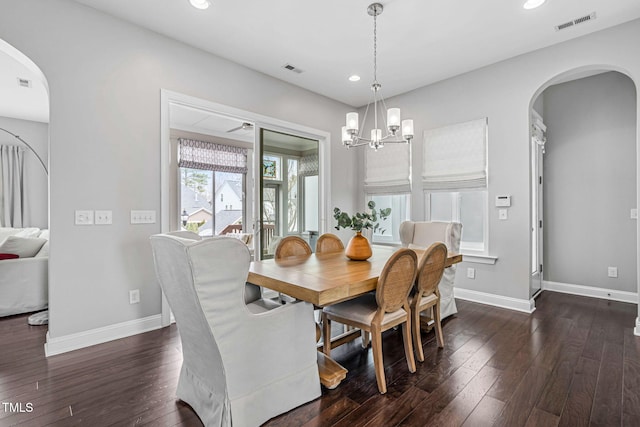 dining area with visible vents, dark wood-type flooring, recessed lighting, arched walkways, and baseboards