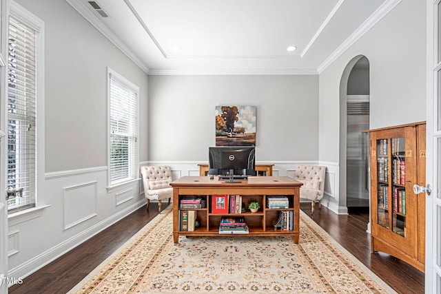 office space featuring arched walkways, visible vents, wainscoting, and wood finished floors