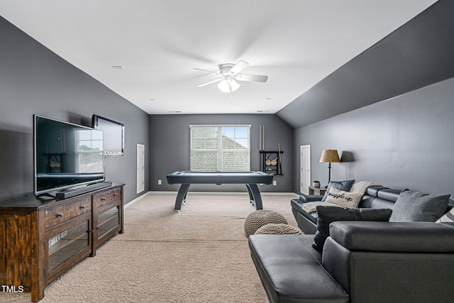 living room featuring baseboards, light colored carpet, ceiling fan, and vaulted ceiling