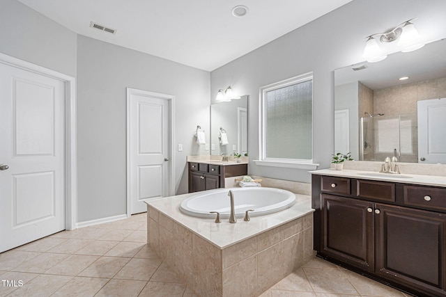 bathroom with visible vents, a shower stall, tile patterned floors, a bath, and a sink