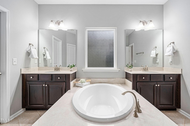 bathroom with a sink, two vanities, and a bath