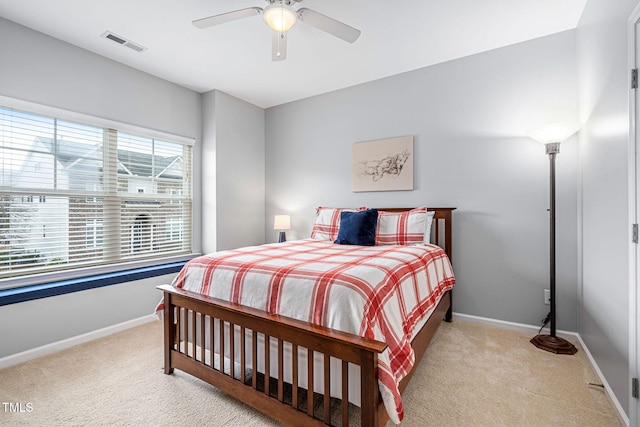 bedroom with visible vents, baseboards, and light colored carpet