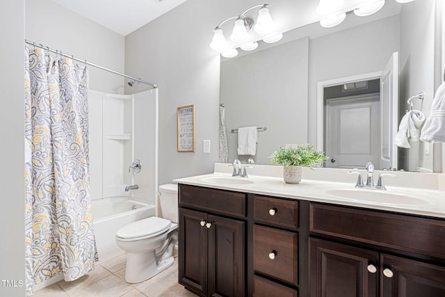 full bath with double vanity, tile patterned floors, toilet, and a sink