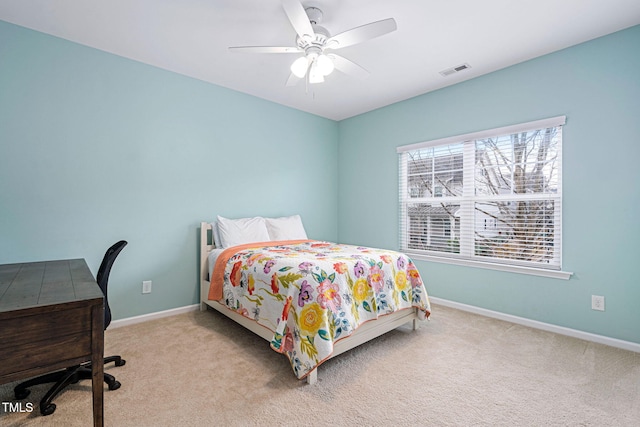 bedroom featuring a ceiling fan, visible vents, baseboards, and carpet floors