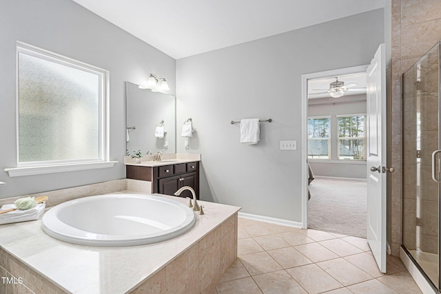 bathroom with a bath, tile patterned flooring, a shower stall, and ensuite bathroom