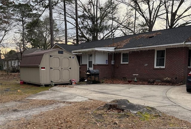 back of house featuring a storage unit