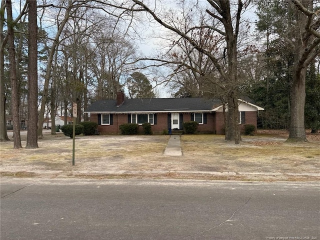 201 S Elm St, Maxton, NC 28364 - single story home featuring a chimney and brick siding