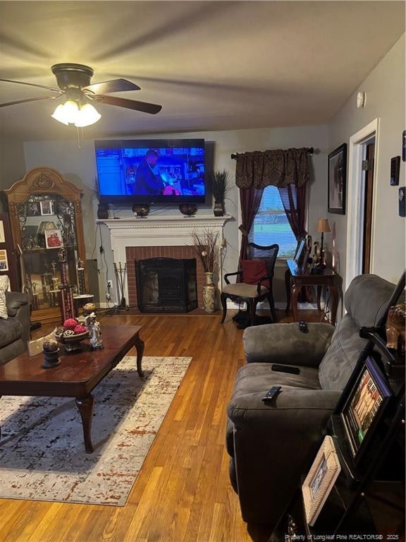 201 S Elm St, Maxton, NC 28364 - living room with a ceiling fan, wood finished floors, and a brick fireplace