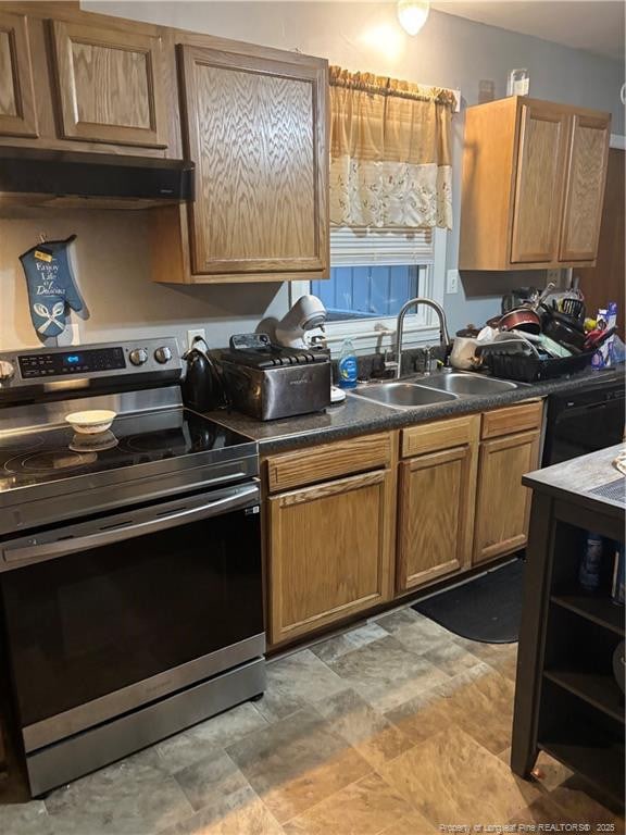 201 S Elm St, Maxton, NC 28364 - kitchen featuring stainless steel range with electric cooktop, a sink, under cabinet range hood, dark countertops, and stone finish floors