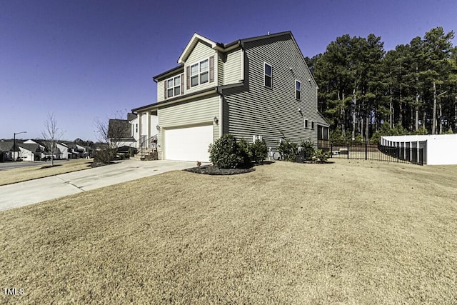 view of side of home featuring a garage and a yard