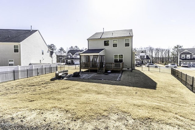 rear view of house with a patio, a sunroom, and a lawn