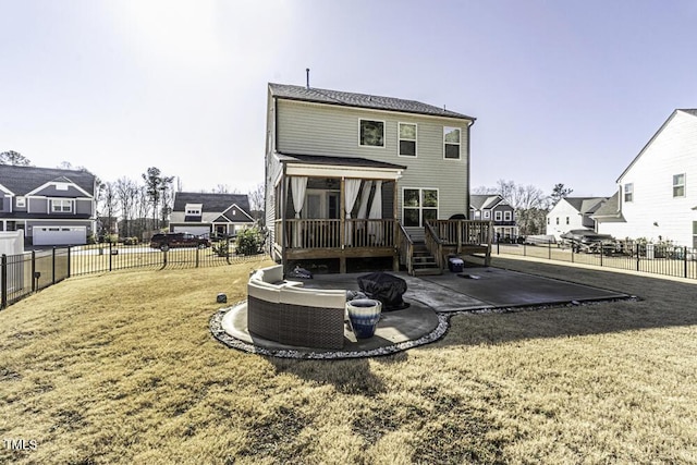 rear view of property with a yard, a deck, and a patio area