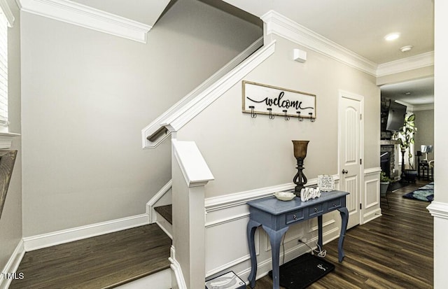 staircase with crown molding and wood-type flooring