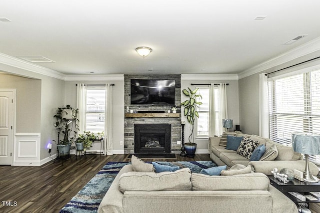 living room with ornamental molding, dark hardwood / wood-style flooring, and a fireplace