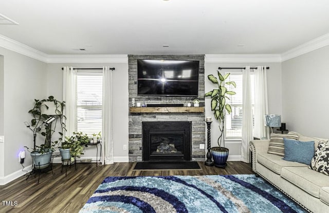 living room featuring dark hardwood / wood-style floors, ornamental molding, a fireplace, and a wealth of natural light