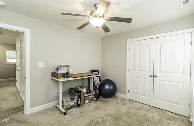 miscellaneous room with ceiling fan and light carpet