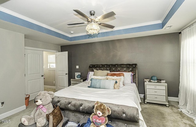 carpeted bedroom featuring a raised ceiling, ornamental molding, and ceiling fan