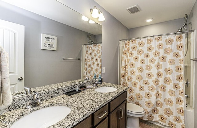 full bathroom featuring vanity, shower / bath combo, and toilet