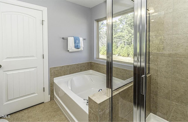 bathroom featuring plus walk in shower and tile patterned floors