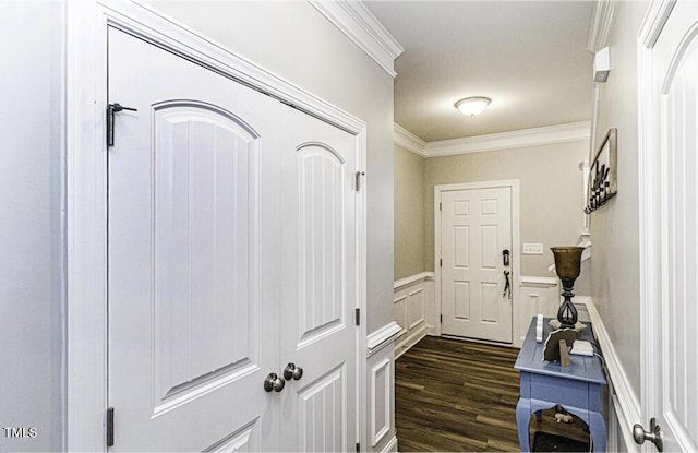 corridor with dark hardwood / wood-style flooring and crown molding