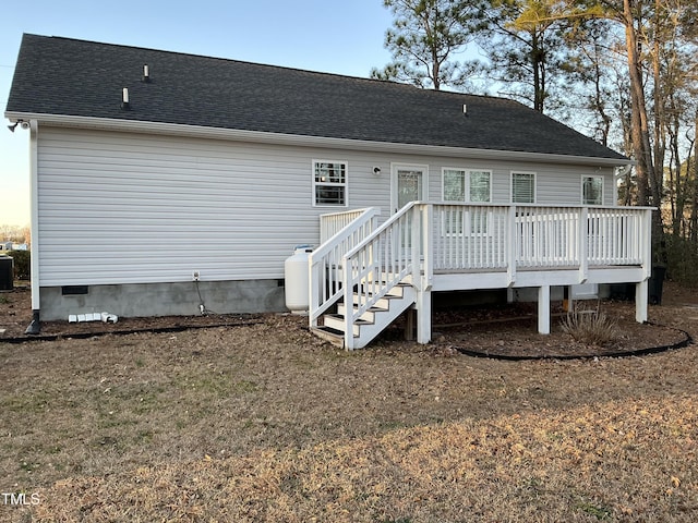 rear view of house featuring central AC unit and a deck