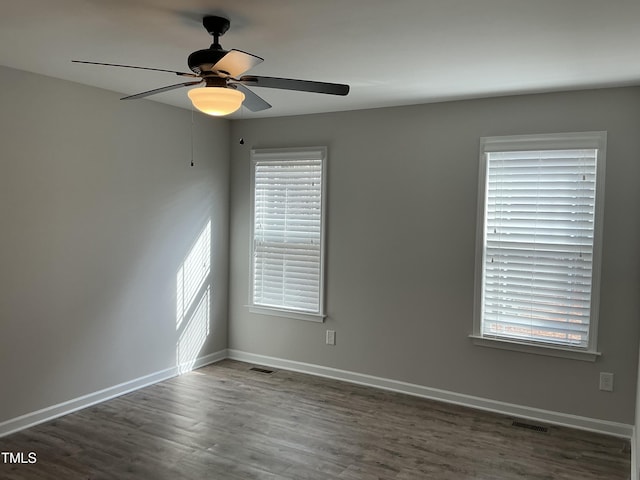 unfurnished room featuring ceiling fan and dark hardwood / wood-style flooring