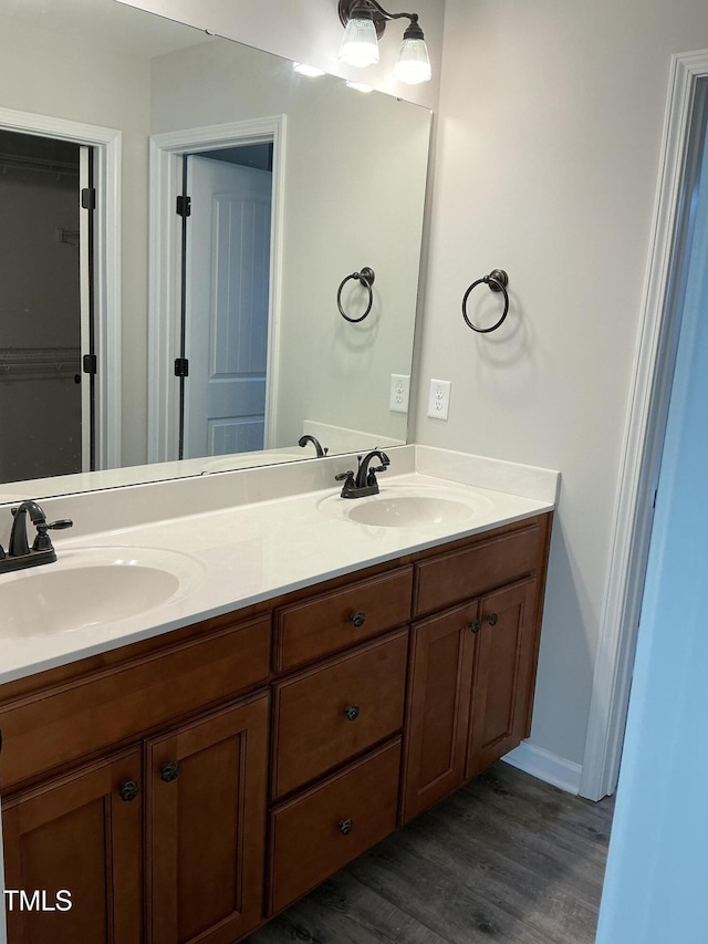 bathroom with hardwood / wood-style flooring and vanity