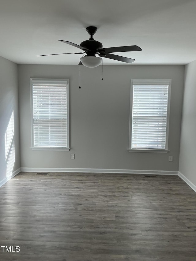 spare room with dark hardwood / wood-style flooring