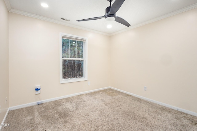 spare room featuring crown molding, carpet flooring, and ceiling fan