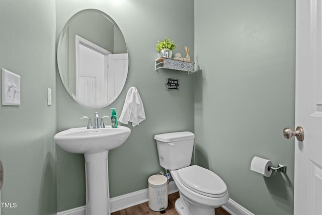 bathroom featuring hardwood / wood-style floors, sink, and toilet