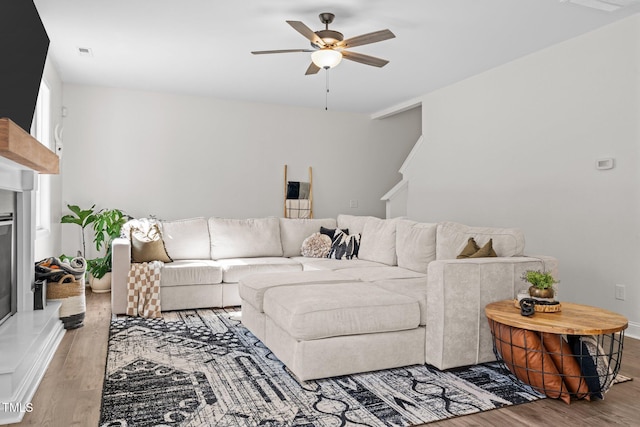 living room featuring ceiling fan and hardwood / wood-style floors