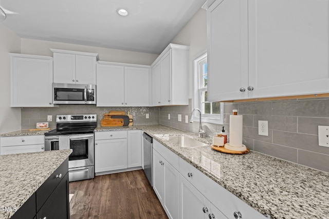 kitchen with sink, white cabinets, and appliances with stainless steel finishes