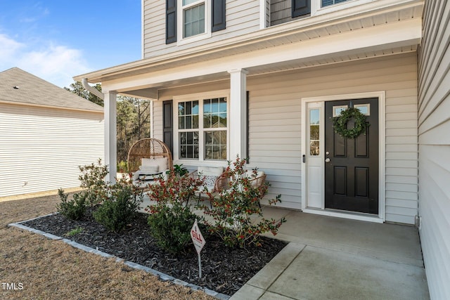 doorway to property featuring covered porch