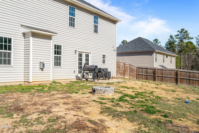 rear view of property with french doors and an outdoor fire pit